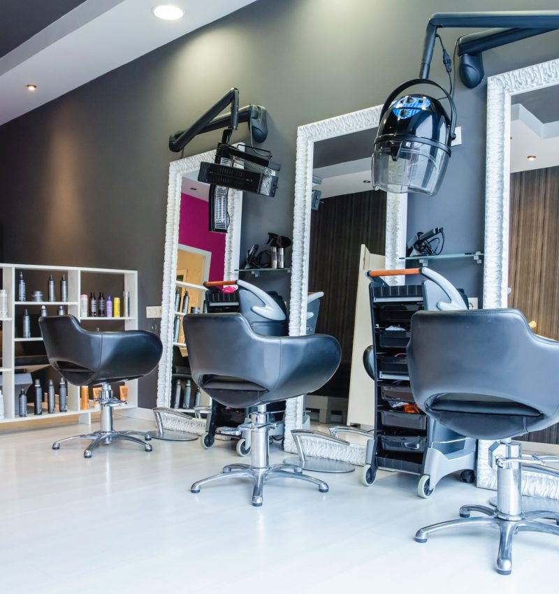 Interior of empty modern hair and beauty salon decorated in gray and fuchsia colors